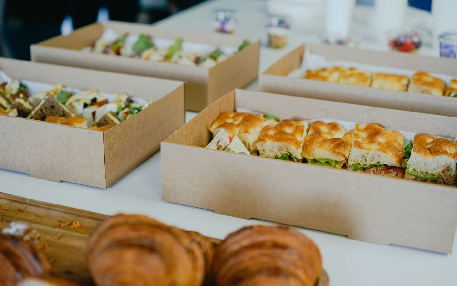 Boxes of sandwiches and pastries on a table